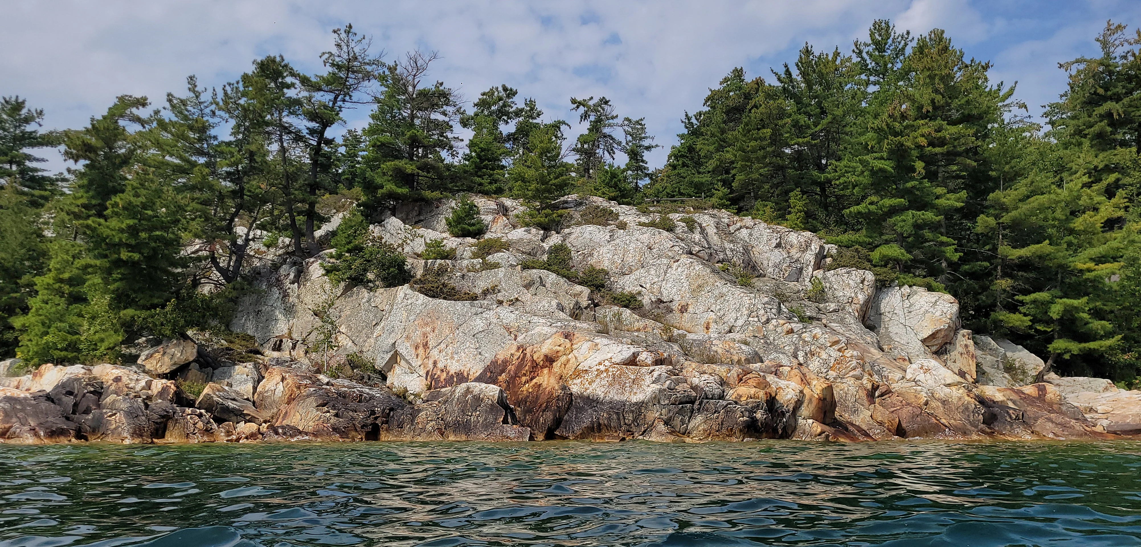 White quartzite cliffs and pine trees in Killarney Bay Ontario